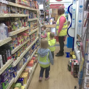 We make regular visits around the local area. We always wear our high visibility jackets to keep us safe. Here we are at the Post Office where we used real money to buy things.